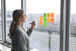 woman writing on sticky notes