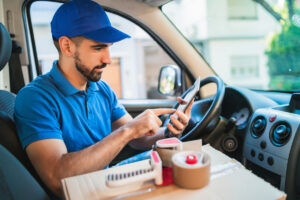 delivery driver using a mobile phone in the front seat of car