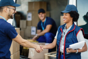 warehouse worker shaking hands with a colleague