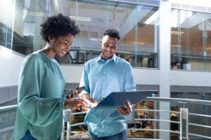 two warehouse workers looking at a tablet