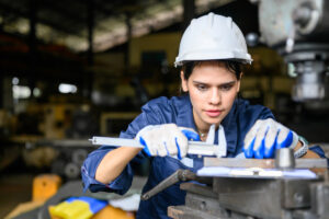 manufacturing warehouse worker using a measuring instrument