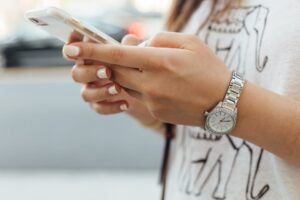 Human hands using a mobile phone