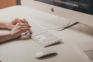 worker typing on a keyboard