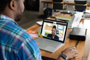 man and woman in a video conferencing session on a laptop