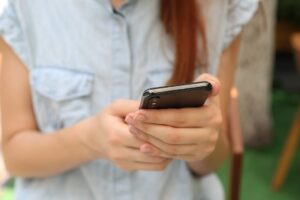 woman holding a mobile phone